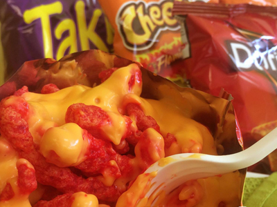 A bag Of Cheetos Smothered With Cheese.