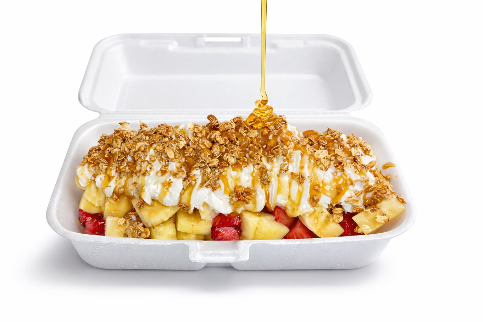 Fragolada with strawberries, banana, pineapple, ice cream, whipped cream, granola and honey